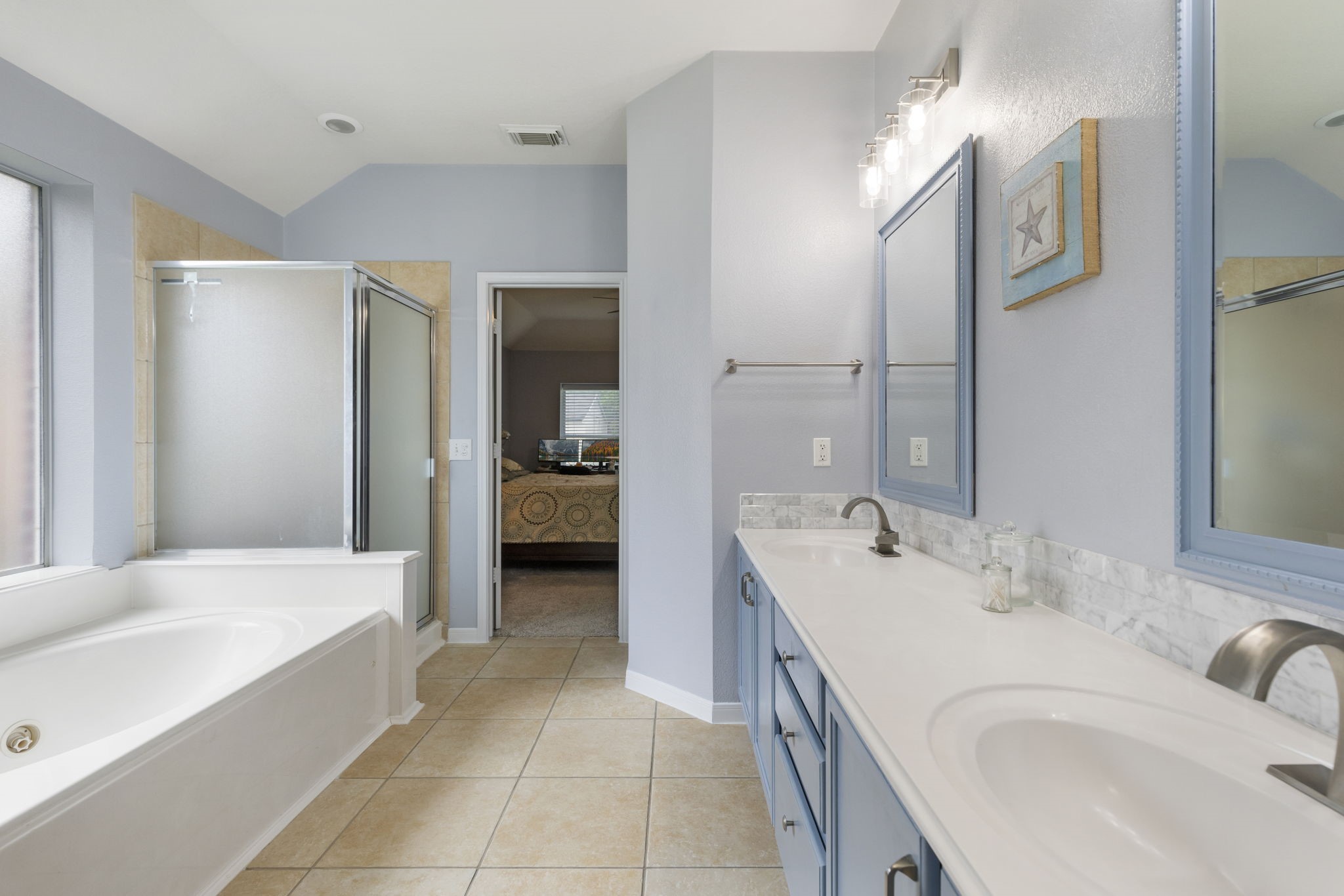 20019 Hardsville Drive Spring, TX 77388 - Photo 20 of 28 a spacious bathroom with a tub sink and mirror