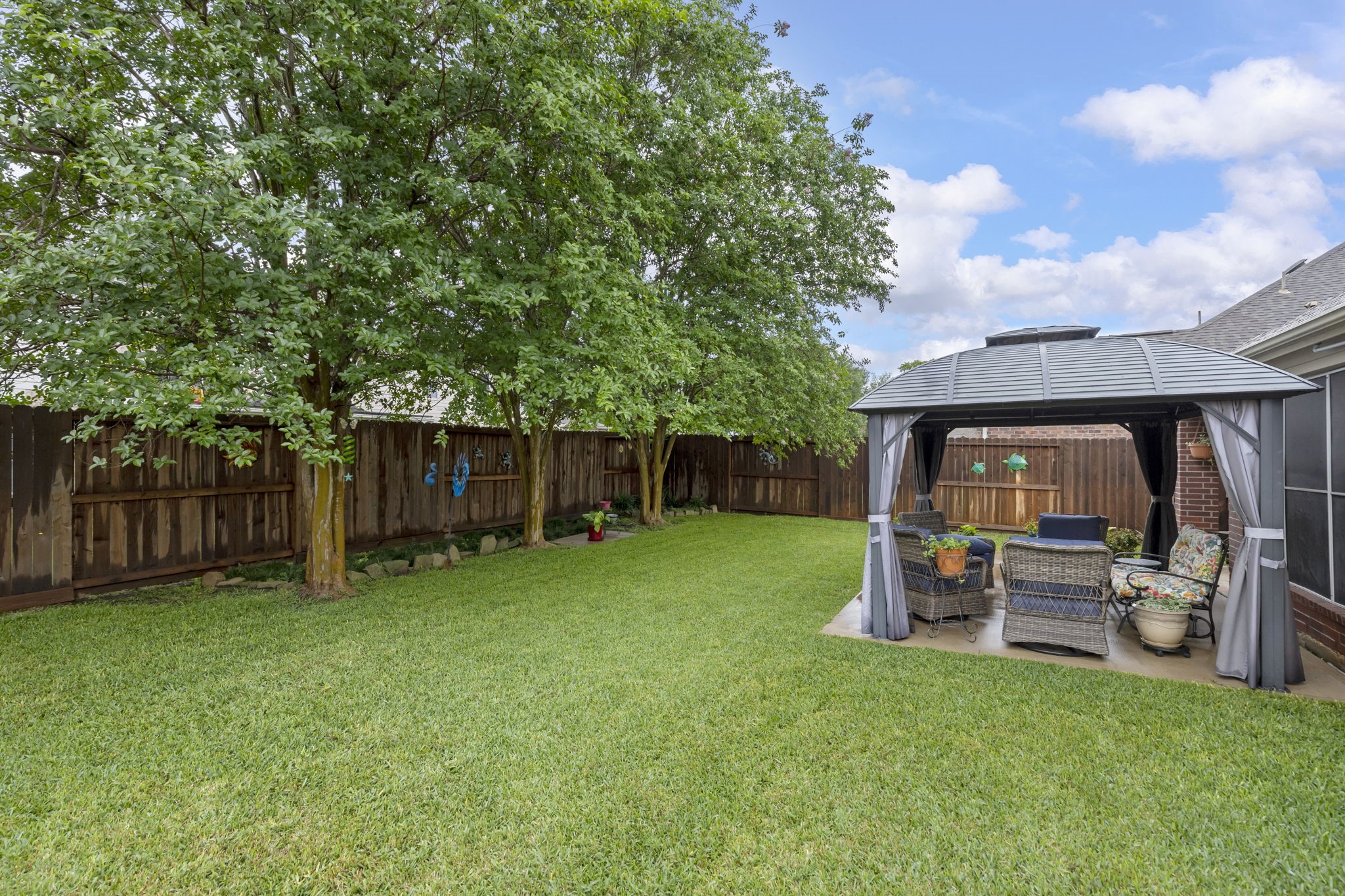 20019 Hardsville Drive Spring, TX 77388 - Photo 25 of 28 a view of a backyard with table and chairs and a large tree