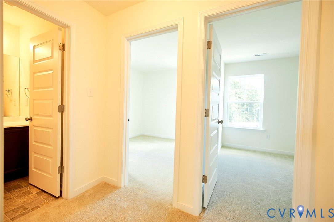 214 Greenpark Road Sandston, VA 23150 - Photo 26 of 50 Hallway featuring light colored carpet and baseboa