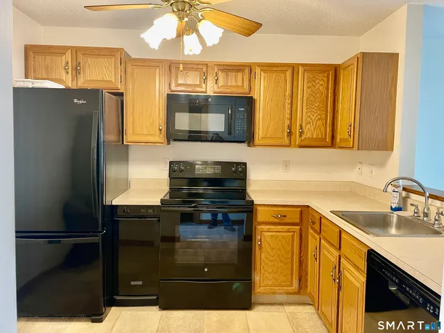 a kitchen with a refrigerator and a sink