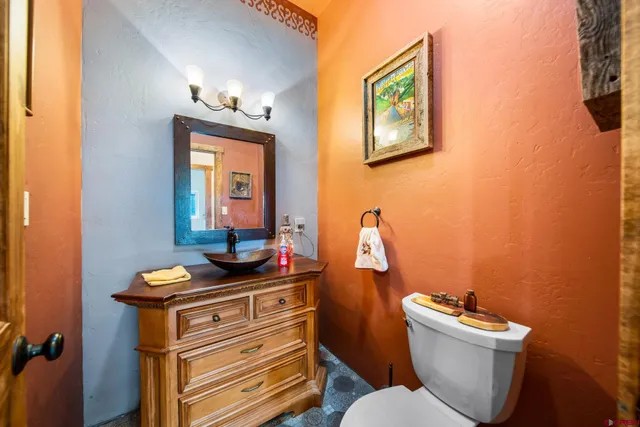 a bathroom with a toilet a sink and mirror