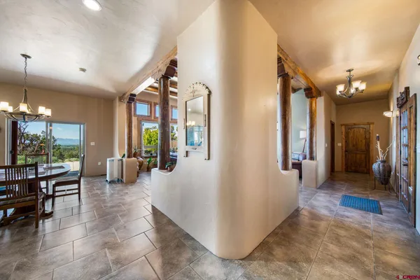 a lobby with furniture and a chandelier