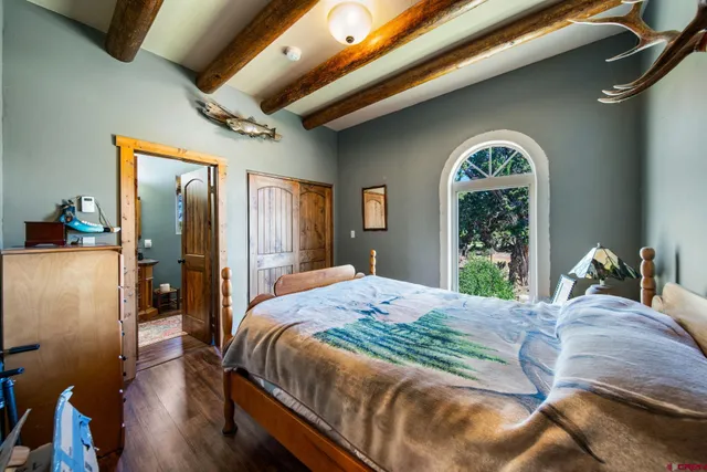 a bedroom with a bed and a large window