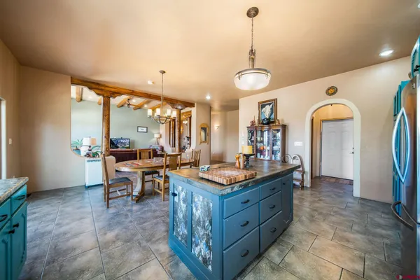 a kitchen with stainless steel appliances granite countertop a sink a stove and a wooden floors