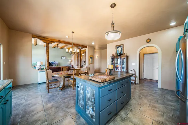 a kitchen with stainless steel appliances granite countertop a sink a stove and a wooden floors