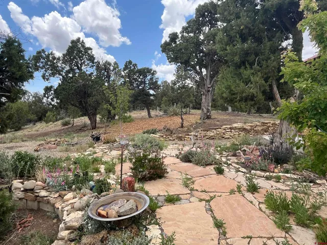 a backyard of a house with table and chairs