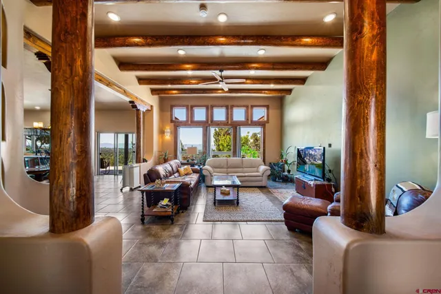 a living room with furniture and a chandelier