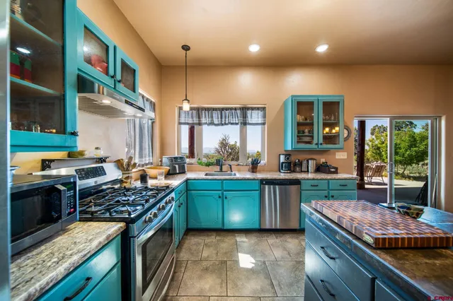 a kitchen with stainless steel appliances granite countertop a stove and a sink