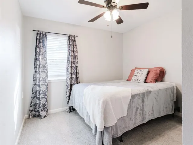 a bedroom with bed and a chandelier