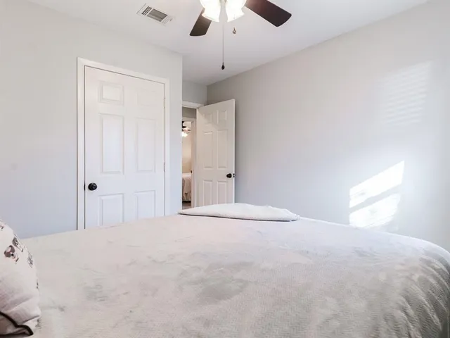 a bathroom with a granite countertop sink a toilet mirror and shower