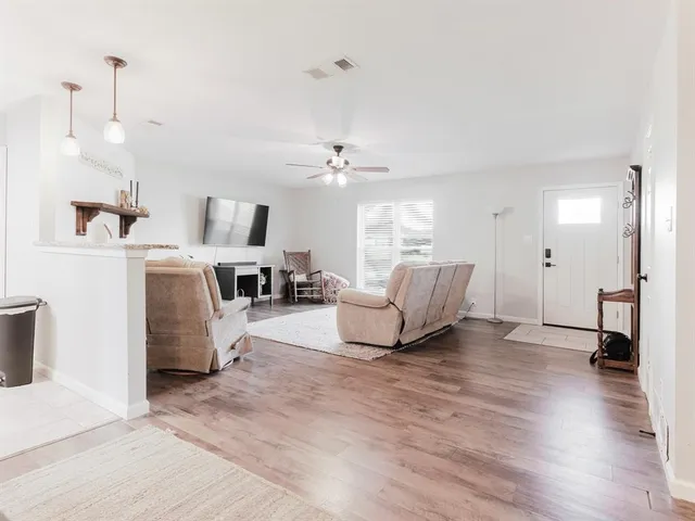 a kitchen with granite countertop a sink stove and cabinets