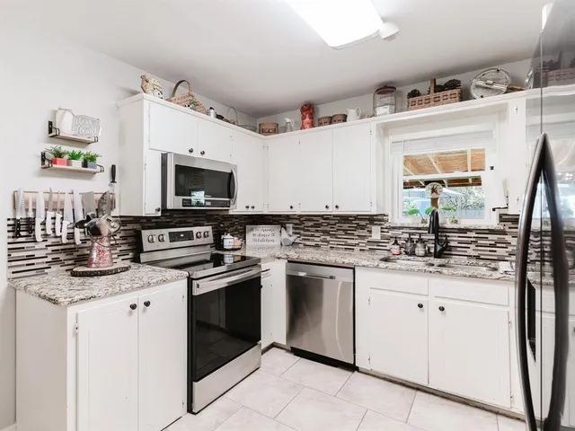 a bed room with bed and a chair