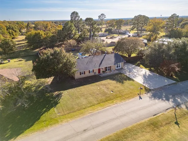 an aerial view of a house with a swimming pool