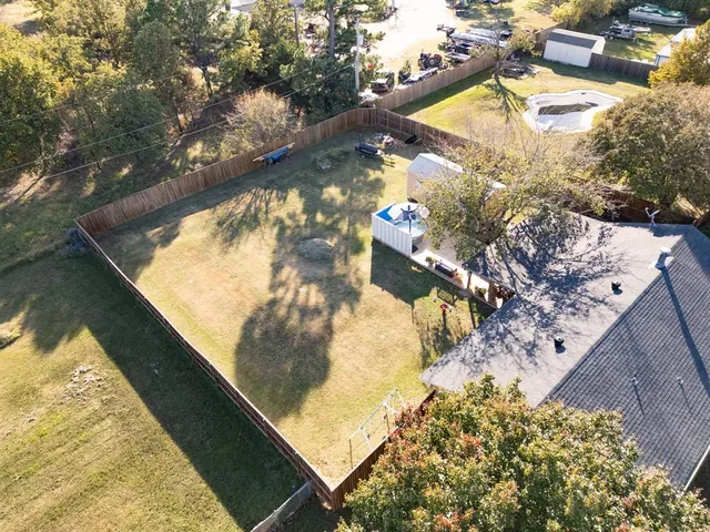 a bathroom with a granite countertop sink a mirror and shower