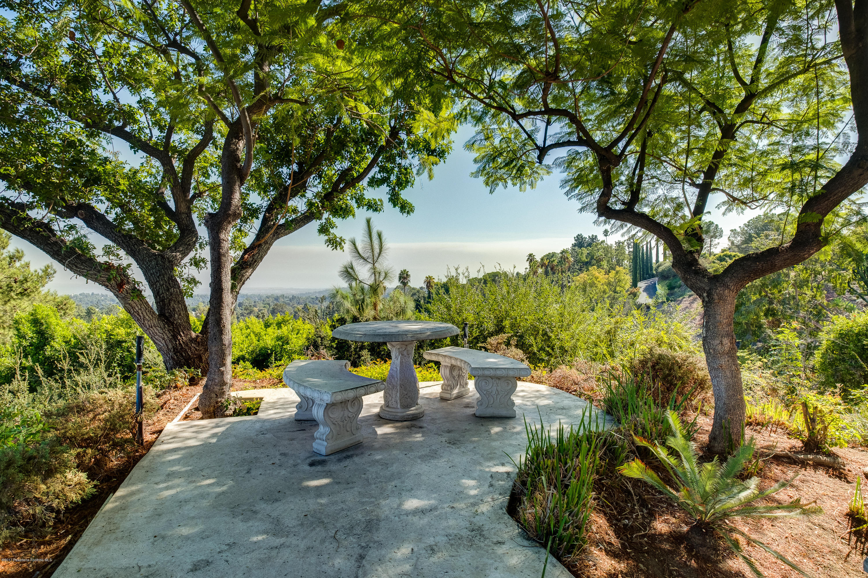 320 Patrician Way Pasadena, CA 91105 - Photo 13 of 69 a view of a white house with a yard and sitting area