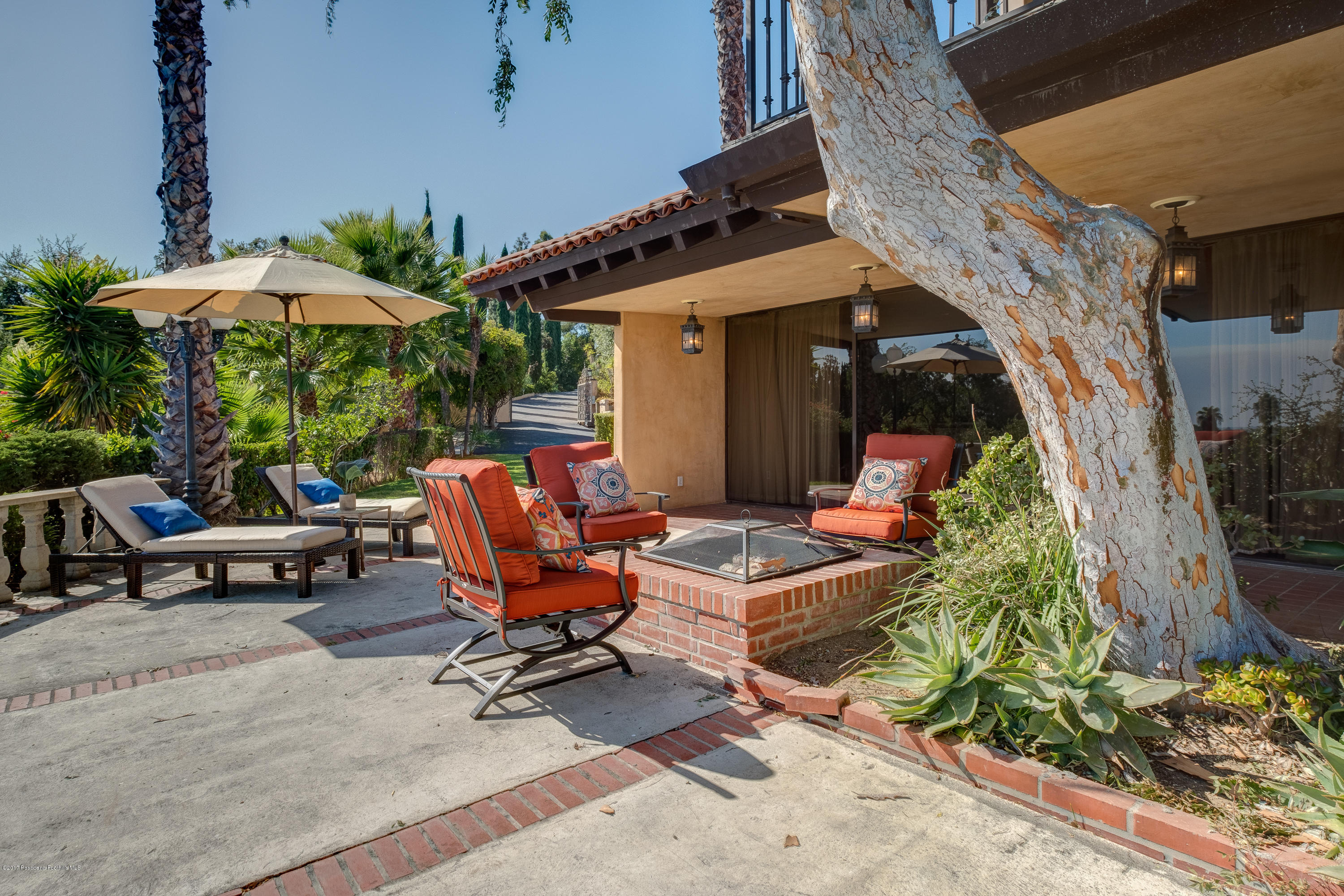 320 Patrician Way Pasadena, CA 91105 - Photo 14 of 69 a view of patio with a table and chairs under an umbrella