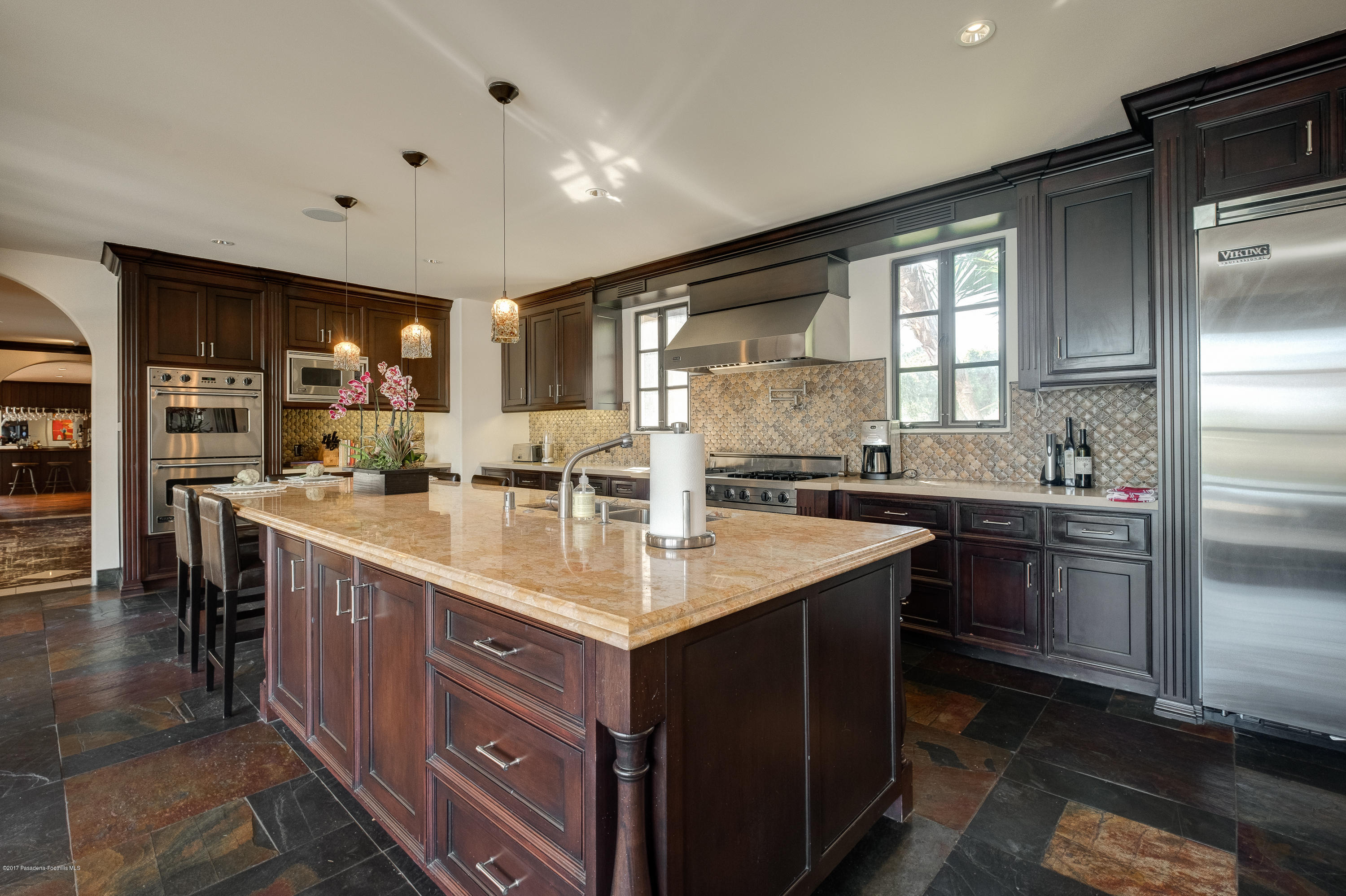320 Patrician Way Pasadena, CA 91105 - Photo 21 of 69 a kitchen with stainless steel appliances granite countertop a sink and stove