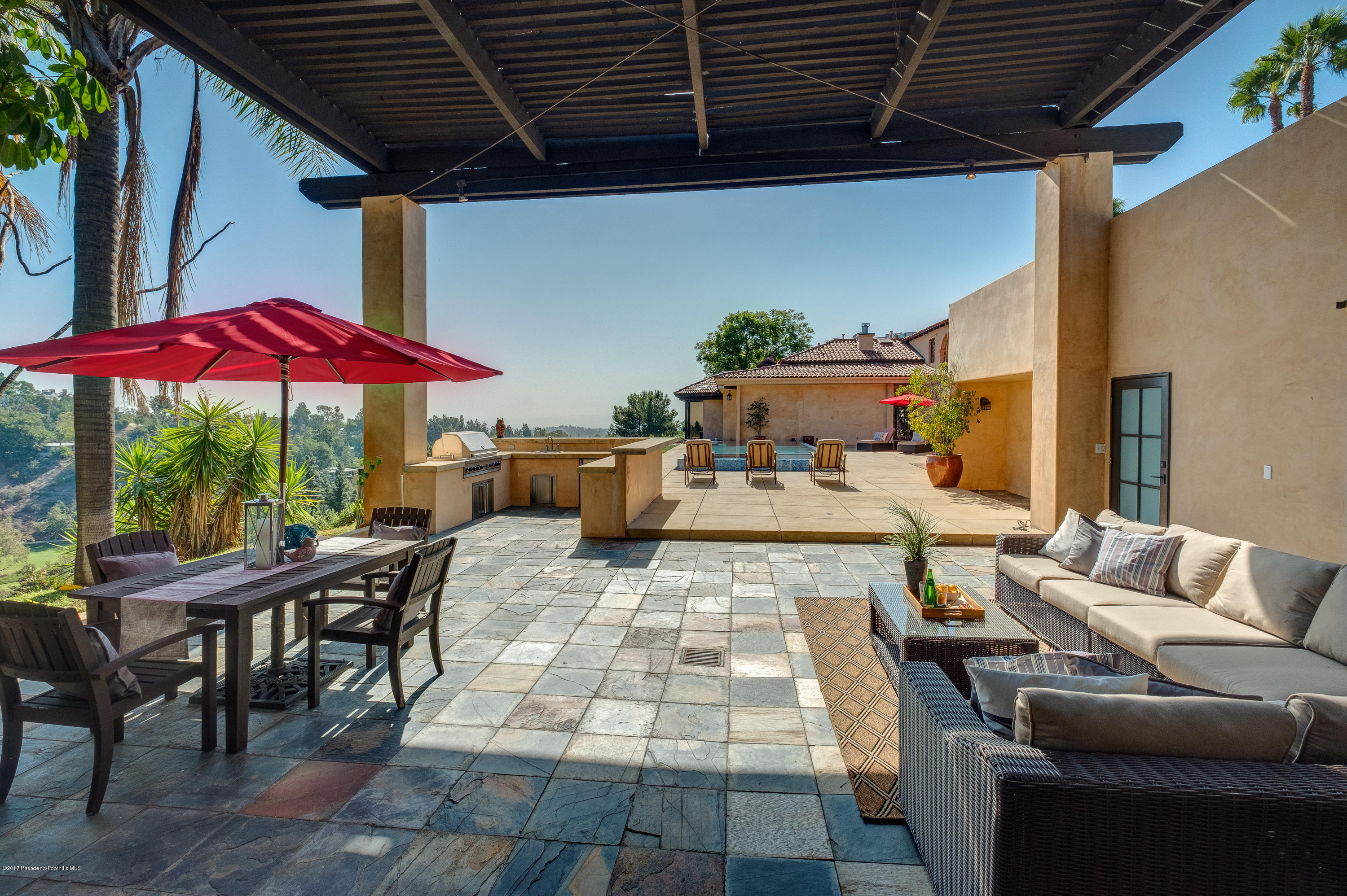 320 Patrician Way Pasadena, CA 91105 - Photo 50 of 69 a view of a patio with a table and chairs under an umbrella