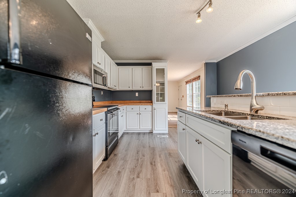 130 Box Elder Terrace Cameron, NC 28326 - Photo 11 of 43 a kitchen with kitchen island granite countertop a sink stove and cabinets