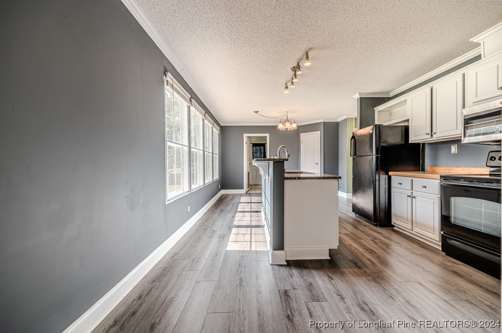 130 Box Elder Terrace Cameron, NC 28326 - Photo 16 of 43 a kitchen with cabinets and wooden floor