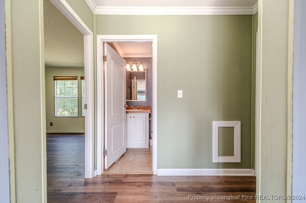 130 Box Elder Terrace Cameron, NC 28326 - Photo 27 of 43 a view of a hallway with wooden floor and a living room
