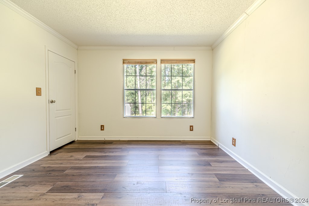 130 Box Elder Terrace Cameron, NC 28326 - Photo 29 of 43 an empty room with wooden floor and windows