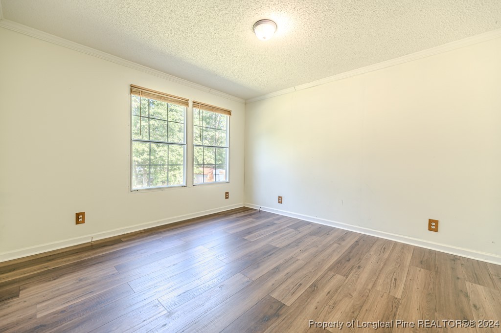 130 Box Elder Terrace Cameron, NC 28326 - Photo 30 of 43 an empty room with wooden floor and windows