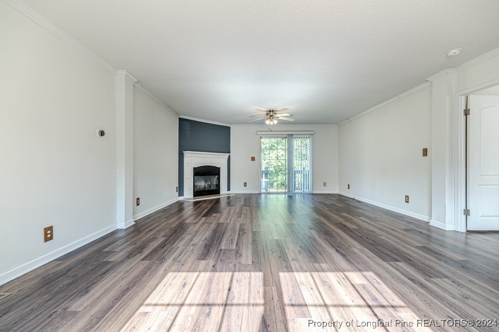 130 Box Elder Terrace Cameron, NC 28326 - Photo 3 of 43 a view of empty room with wooden floor and fireplace