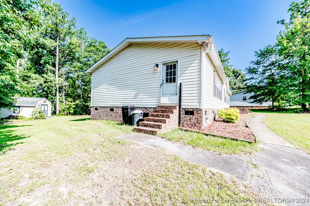 130 Box Elder Terrace Cameron, NC 28326 - Photo 38 of 43 a view of a house with a yard and garage