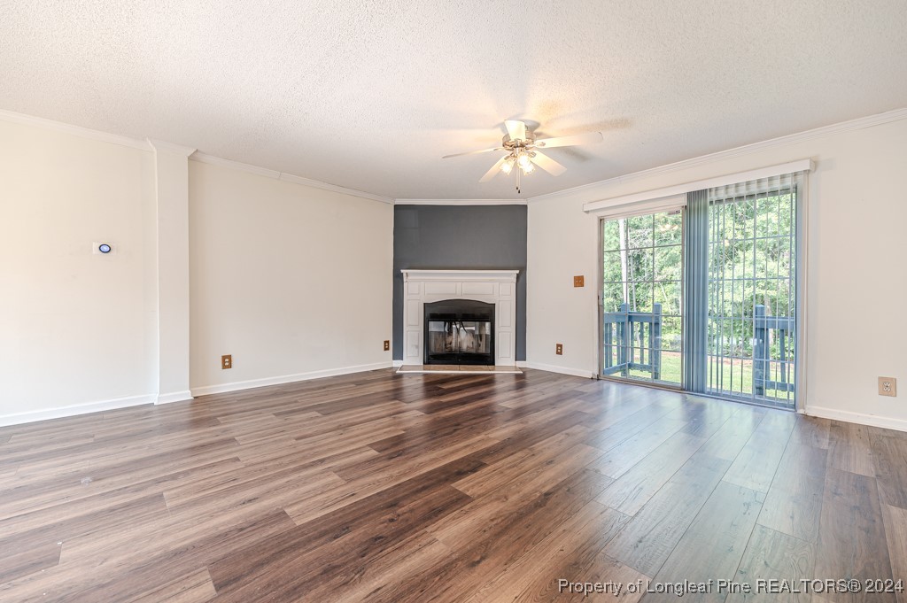 130 Box Elder Terrace Cameron, NC 28326 - Photo 4 of 43 a view of empty room with wooden floor and fireplace