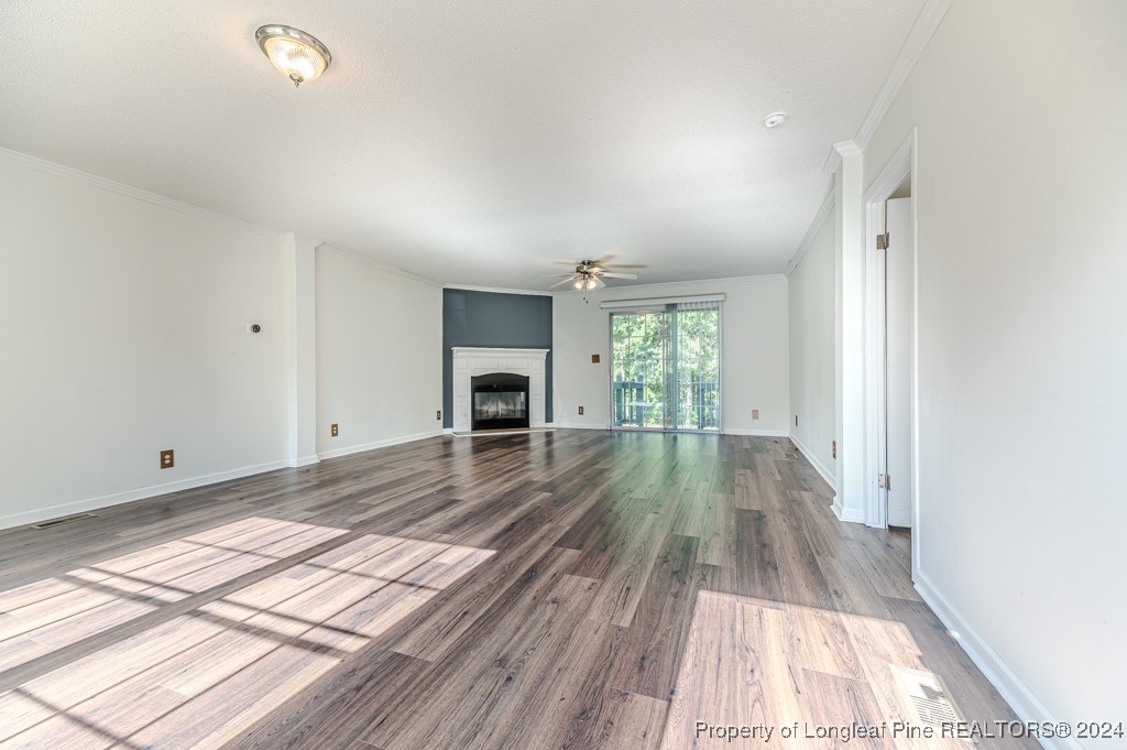 130 Box Elder Terrace Cameron, NC 28326 - Photo 5 of 43 a view of empty room with wooden floor and fireplace