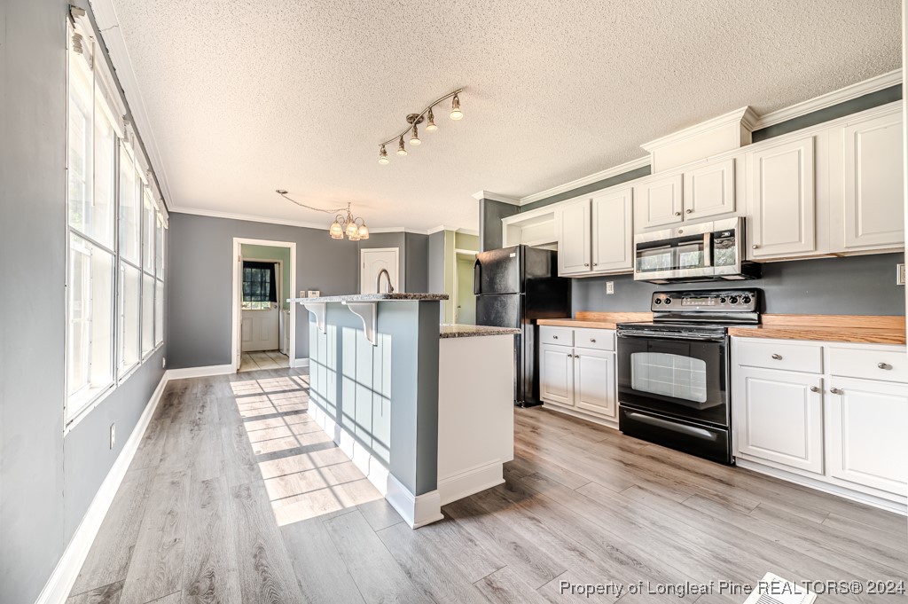 130 Box Elder Terrace Cameron, NC 28326 - Photo 7 of 43 a kitchen with stainless steel appliances a stove a refrigerator sink and microwave