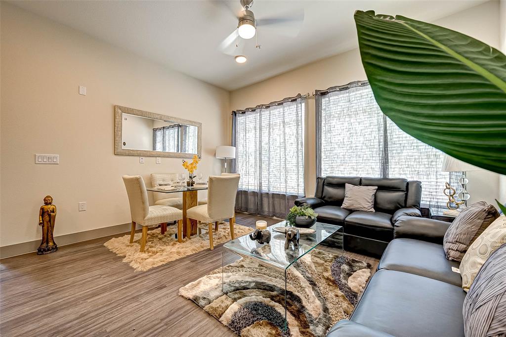 a living room with furniture and a wooden floor