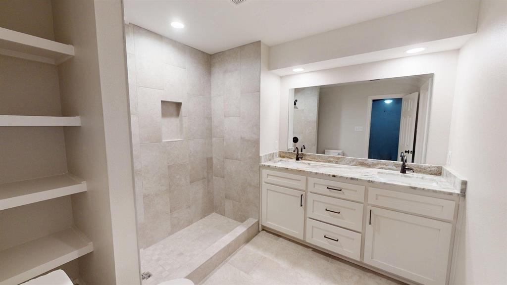 1110 Mill Run Road Athens, TX 75751 - Photo 25 of 32 a bathroom with a granite countertop sink two mirror and a bathtub