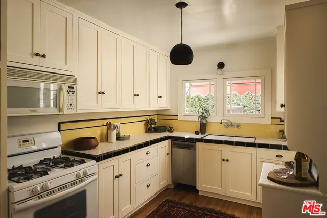 a kitchen with stainless steel appliances granite countertop a sink and a stove