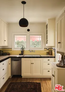 a kitchen with stainless steel appliances granite countertop a sink and cabinets