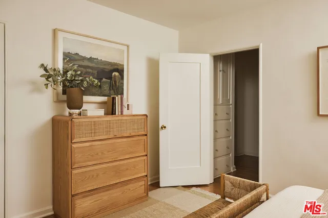 a room with a dresser and mirror