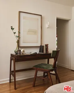 a living room with a table and a potted plant