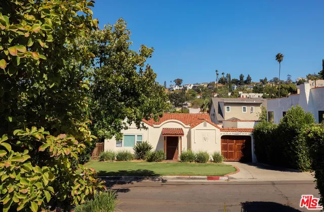 a front view of a house with a garden