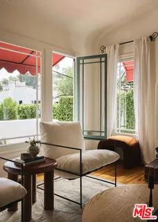 a living room with furniture a rug and a large window