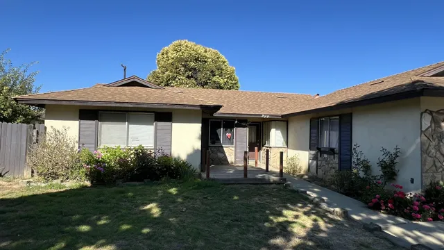 a front view of a house with garden