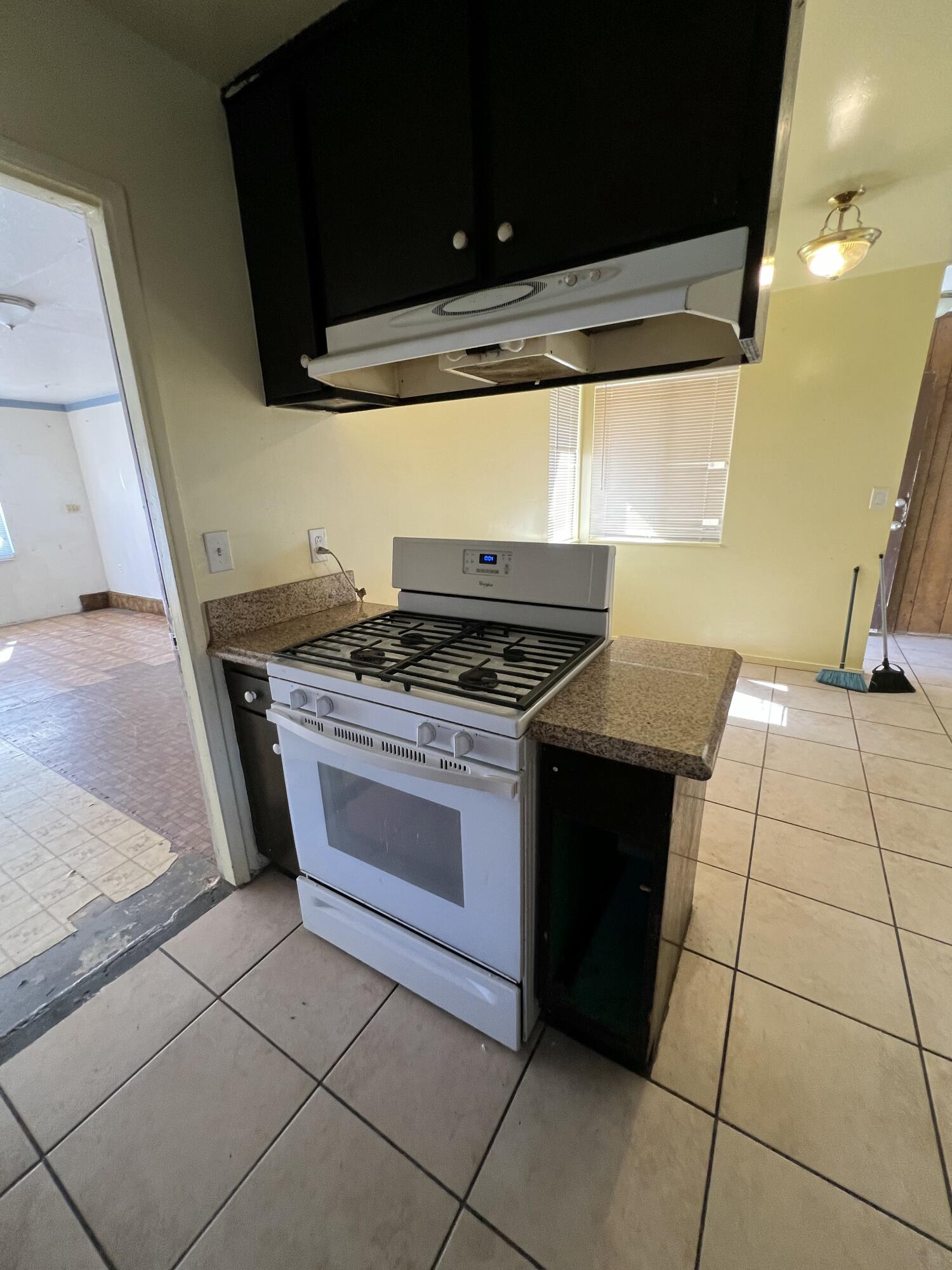 309 V Street Lompoc, CA 93436 - Photo 11 of 24 a kitchen with a stove and a microwave
