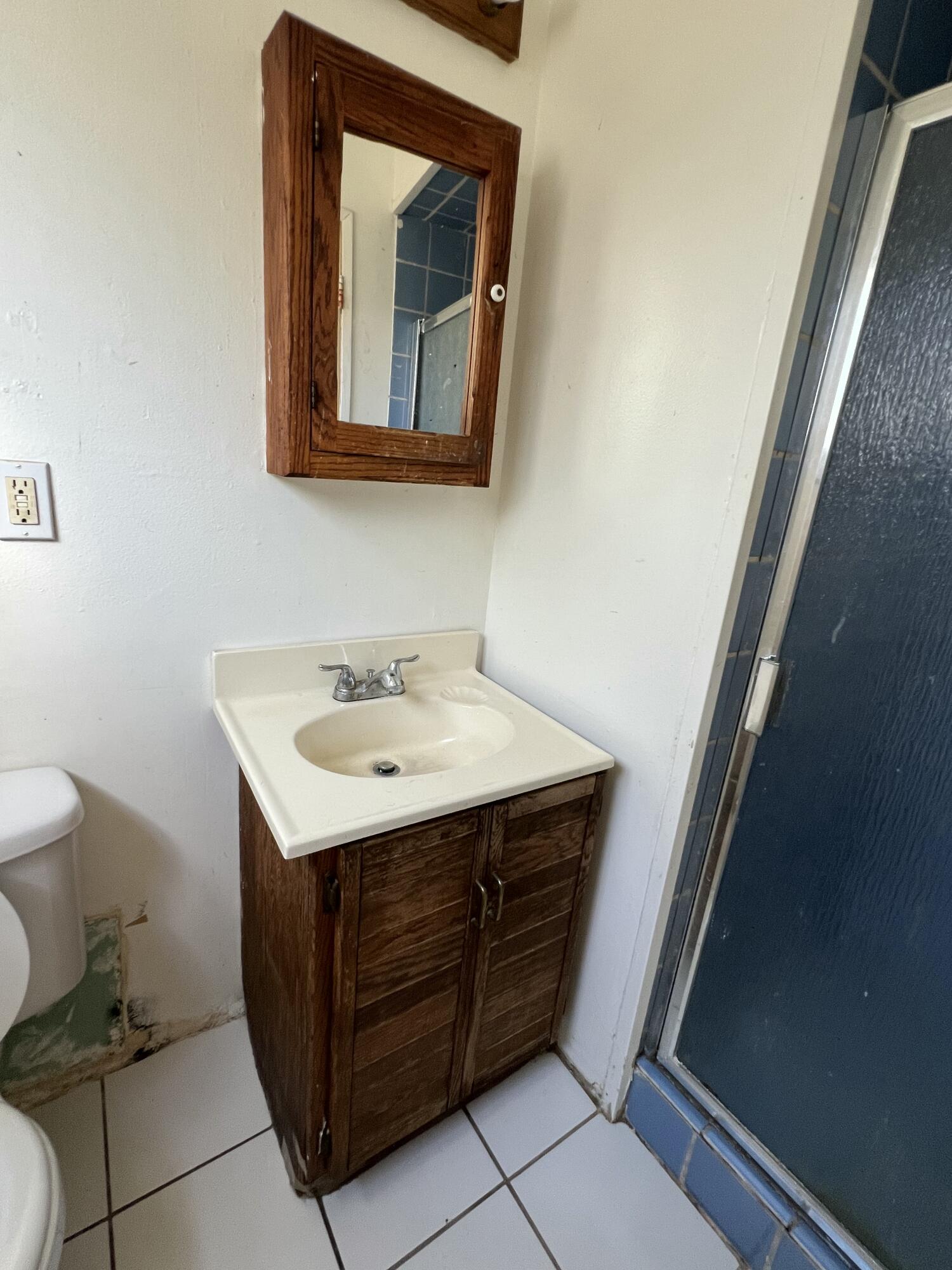 309 V Street Lompoc, CA 93436 - Photo 15 of 24 a utility room with a toilet sink and mirror