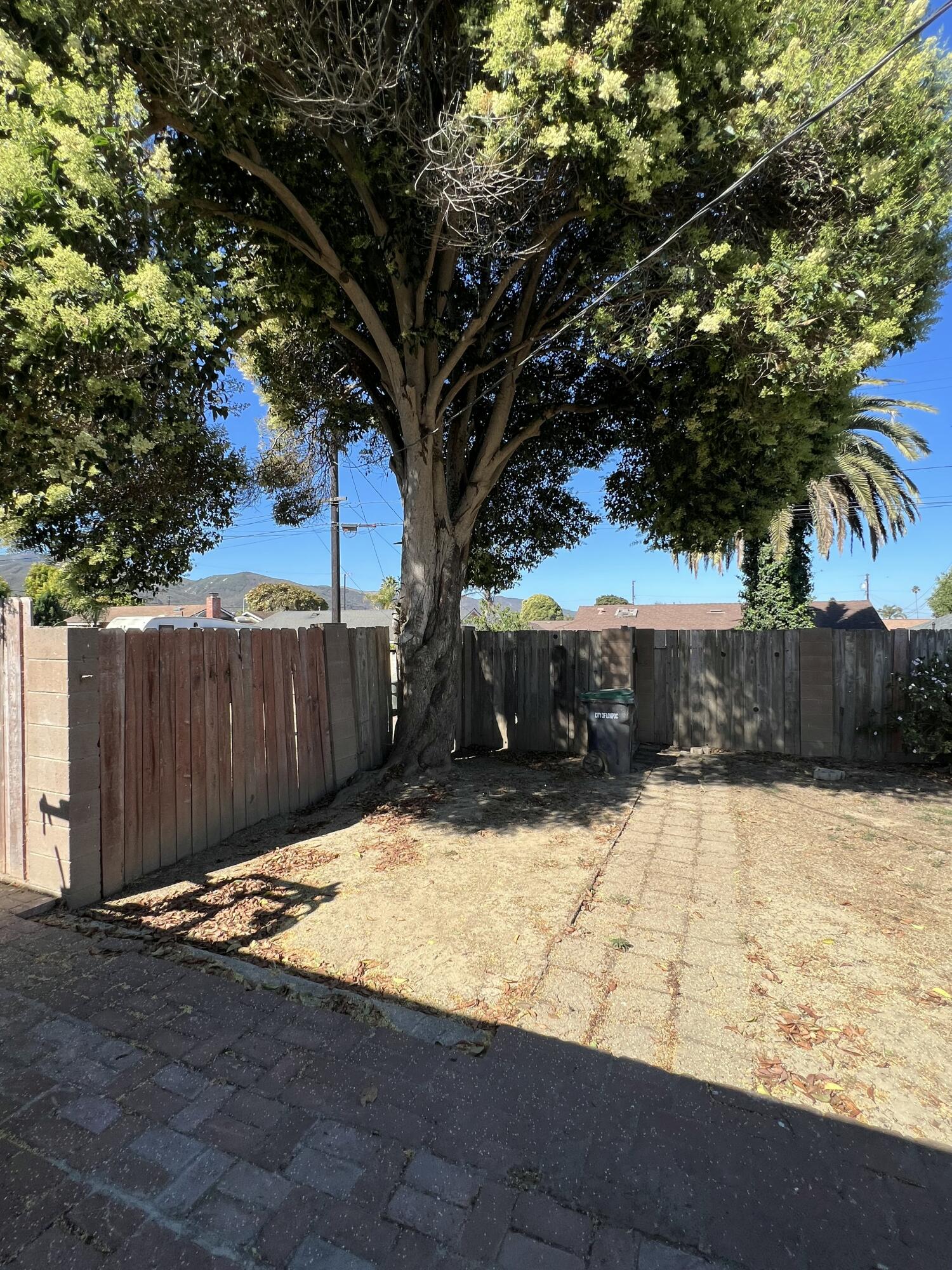 309 V Street Lompoc, CA 93436 - Photo 22 of 24 a view of a yard with wooden fence