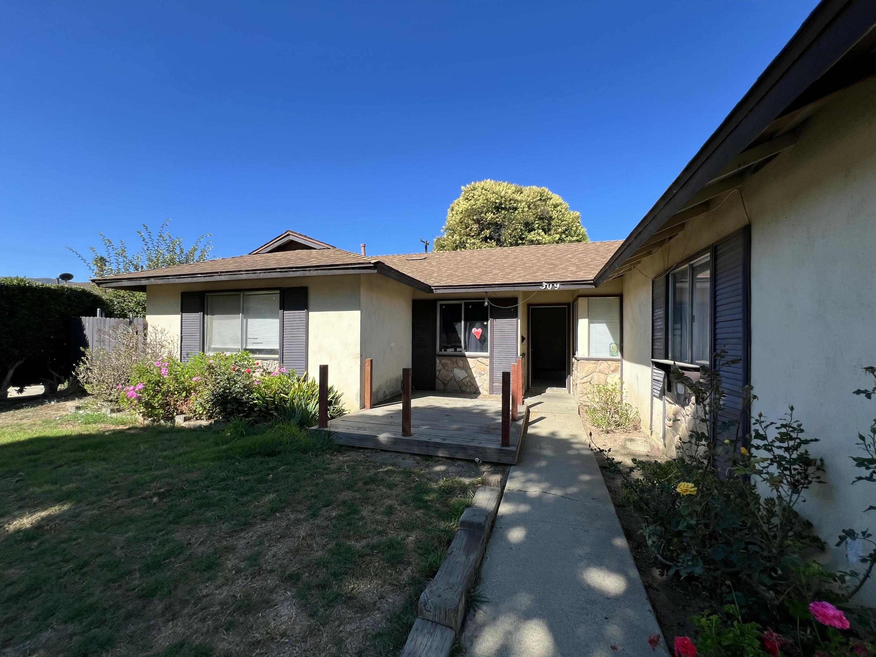 309 V Street Lompoc, CA 93436 - Photo 3 of 24 a front view of a house with garden