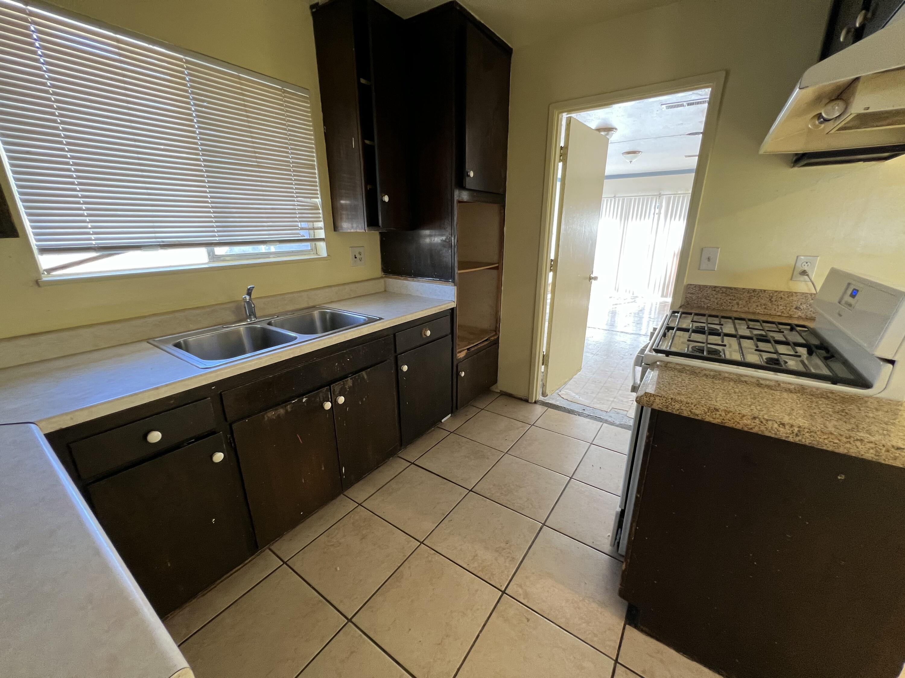 309 V Street Lompoc, CA 93436 - Photo 8 of 24 a kitchen with a sink a stove and cabinets