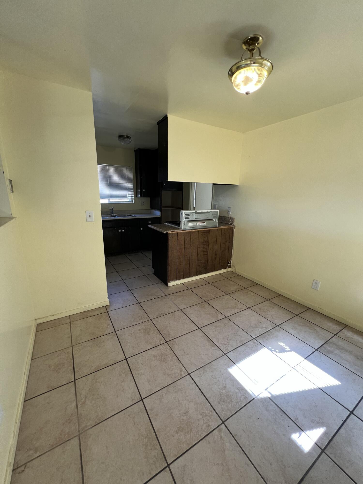 309 V Street Lompoc, CA 93436 - Photo 9 of 24 a kitchen with a sink a stove and a microwave