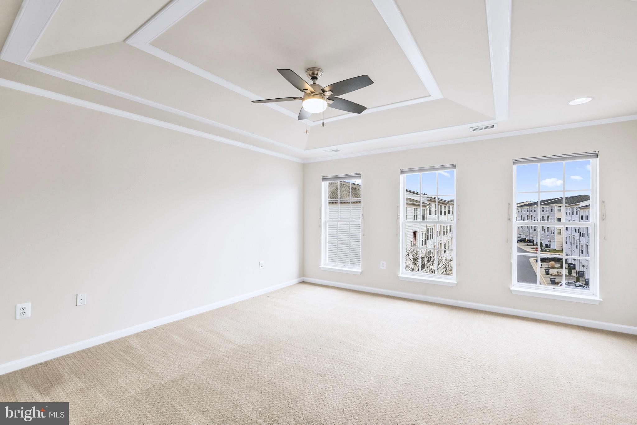 6055 Wicker Lane, Unit 128 Centreville, VA 20121 - Photo 19 of 36 an empty room with windows and ceiling fan
