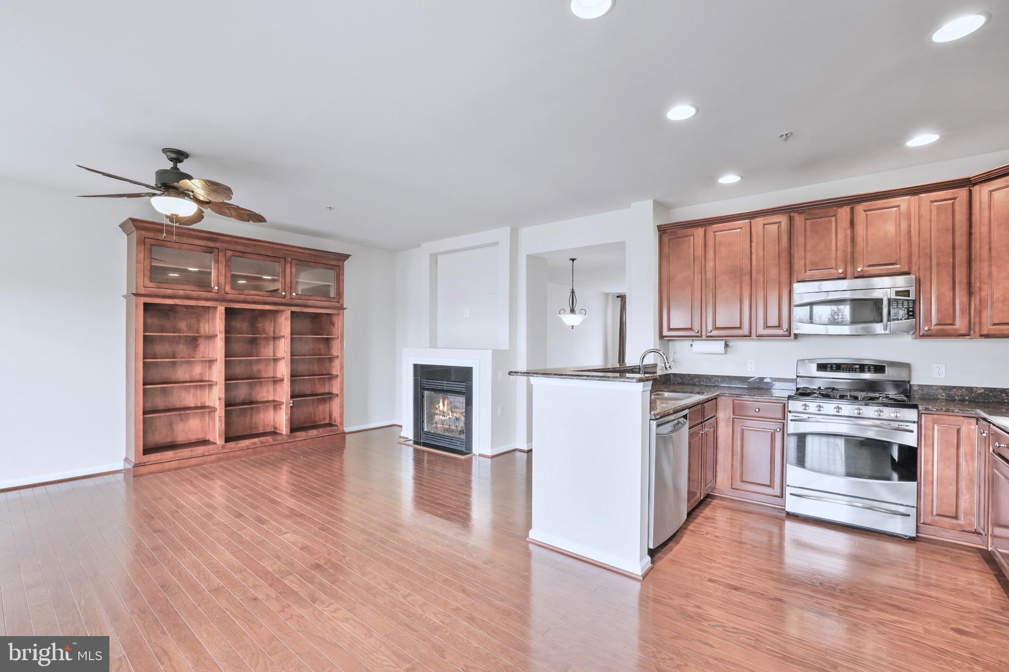 6055 Wicker Lane, Unit 128 Centreville, VA 20121 - Photo 2 of 36 a kitchen with stainless steel appliances granite countertop a stove and a sink