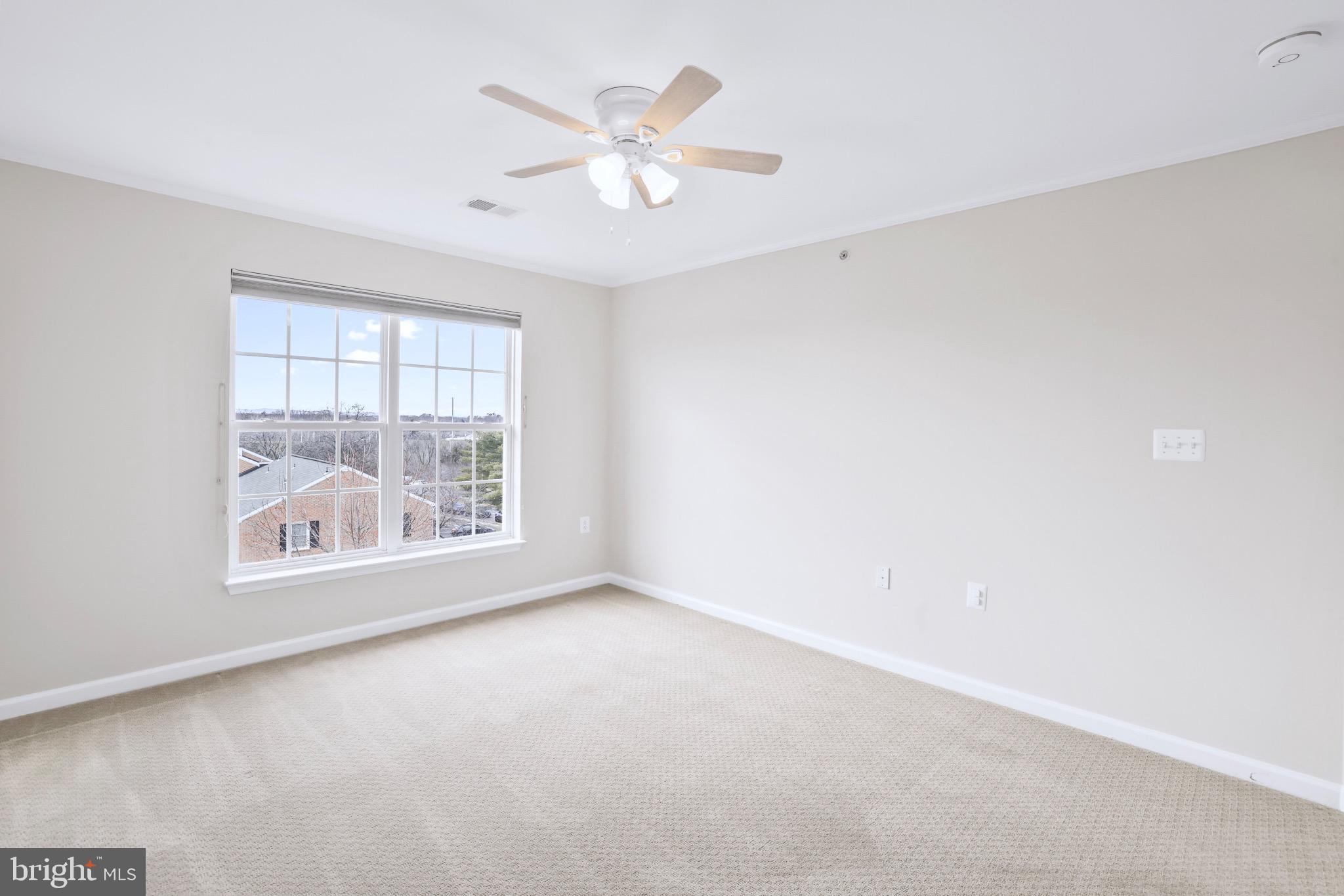 6055 Wicker Lane, Unit 128 Centreville, VA 20121 - Photo 27 of 36 an empty room with a white walls and a large window